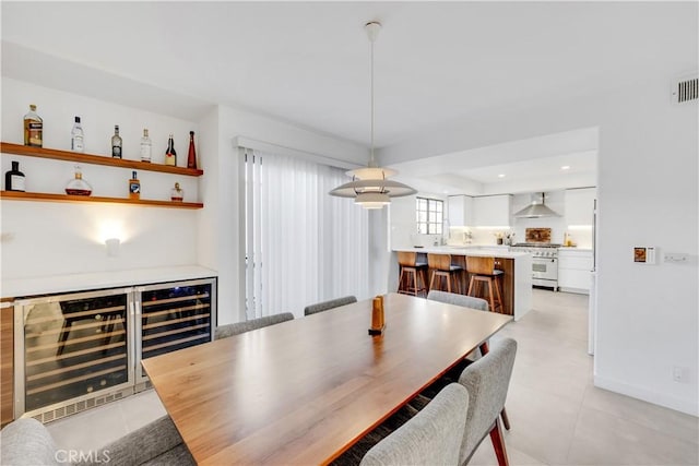 dining area with wine cooler and light tile patterned flooring