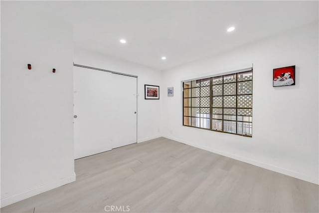 empty room with light hardwood / wood-style flooring