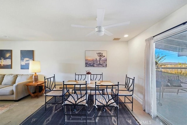 carpeted dining room with ceiling fan