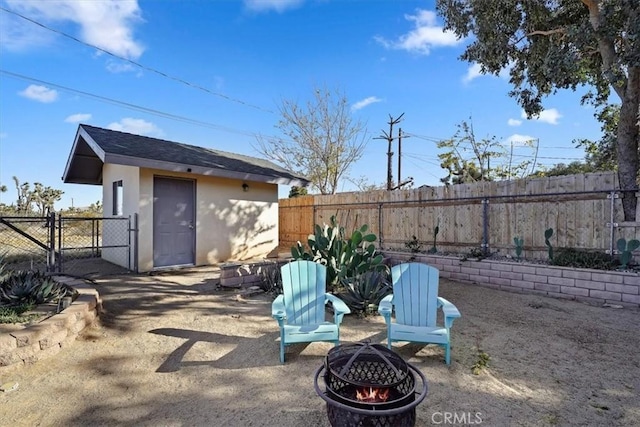 exterior space with a fire pit and an outdoor structure