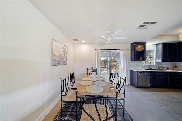 dining area featuring ceiling fan, concrete flooring, and sink