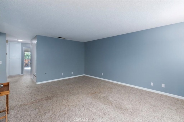 unfurnished room featuring carpet floors and a textured ceiling