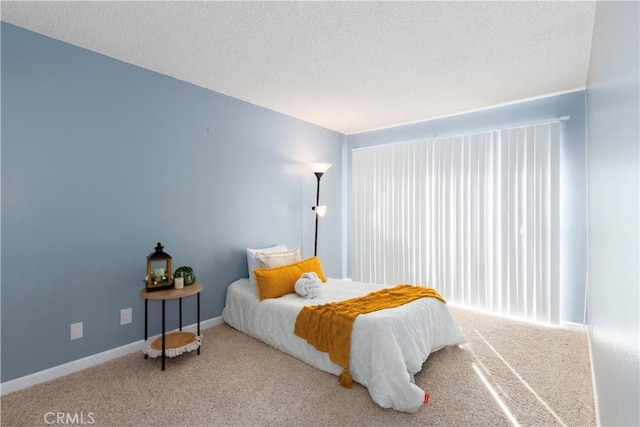 carpeted bedroom with a textured ceiling