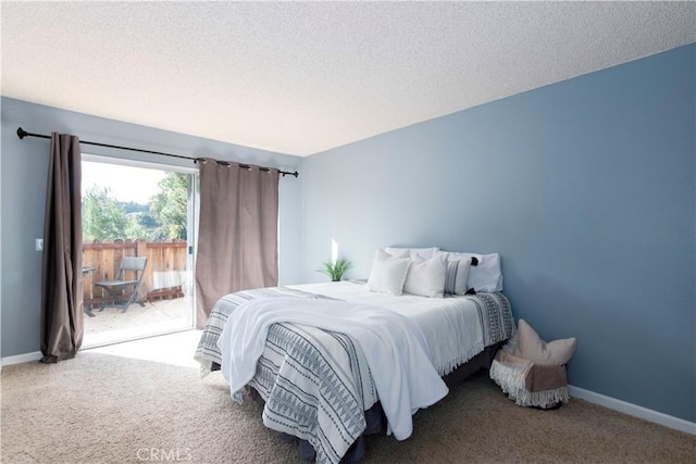 carpeted bedroom featuring a textured ceiling