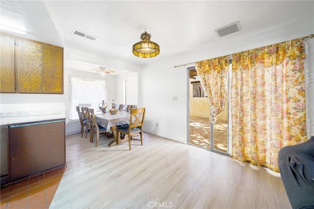 dining space featuring light hardwood / wood-style flooring and ceiling fan