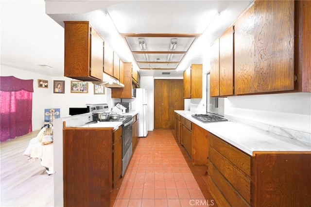 kitchen with light tile patterned flooring and stainless steel appliances