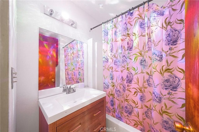 bathroom featuring vanity and shower / bath combination with curtain