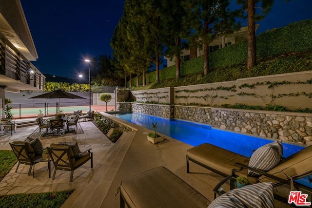 pool at twilight with pool water feature