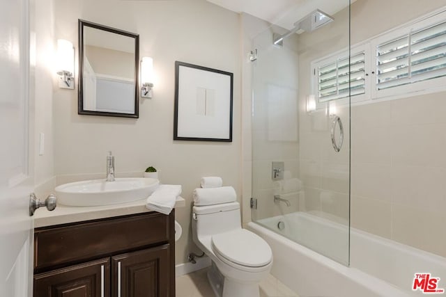 full bathroom featuring toilet, tiled shower / bath combo, and vanity