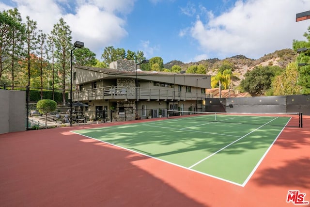 view of sport court with a mountain view