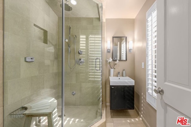 bathroom with vanity, a shower with door, and tile patterned floors