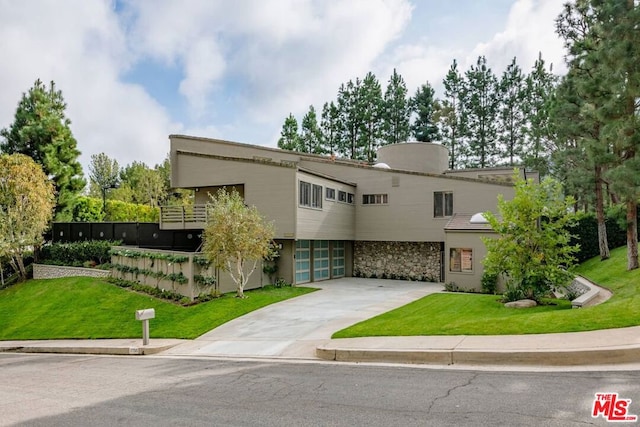 view of front facade with a front yard and a garage