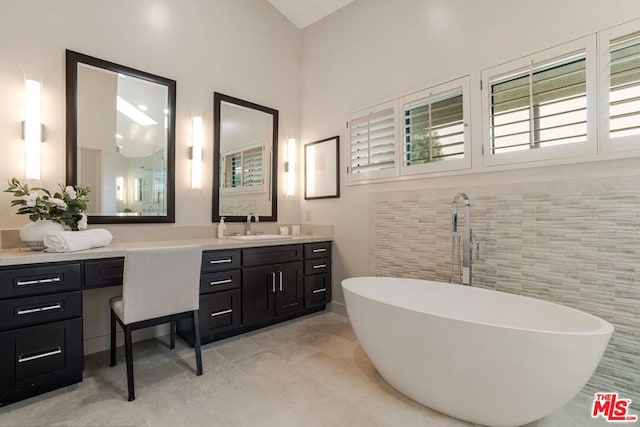 bathroom with vanity and a bath