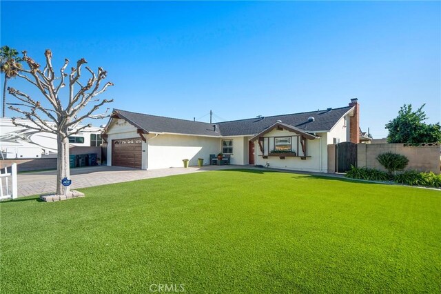 ranch-style home featuring a front lawn and a garage