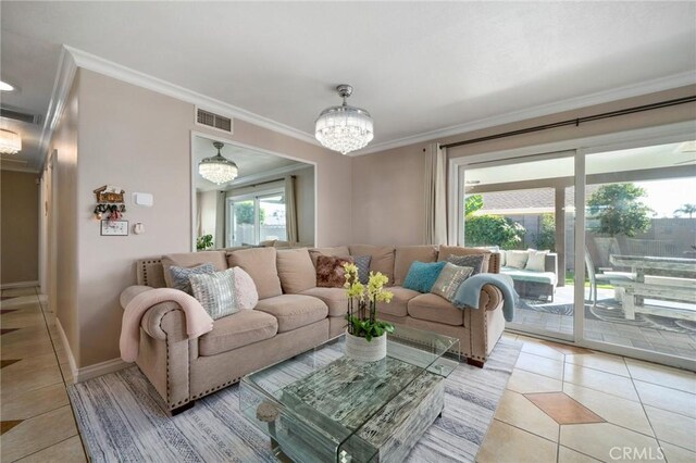 living room featuring crown molding, light tile patterned floors, and a chandelier