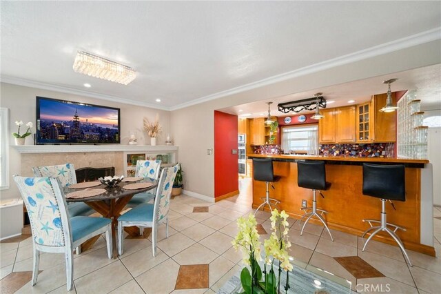 tiled dining area featuring crown molding