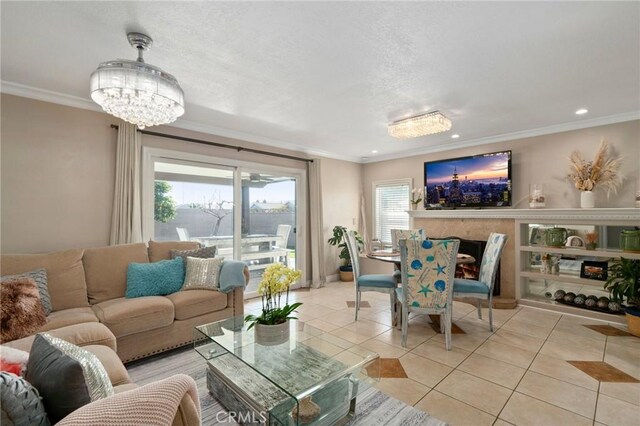 tiled living room with plenty of natural light, crown molding, and an inviting chandelier