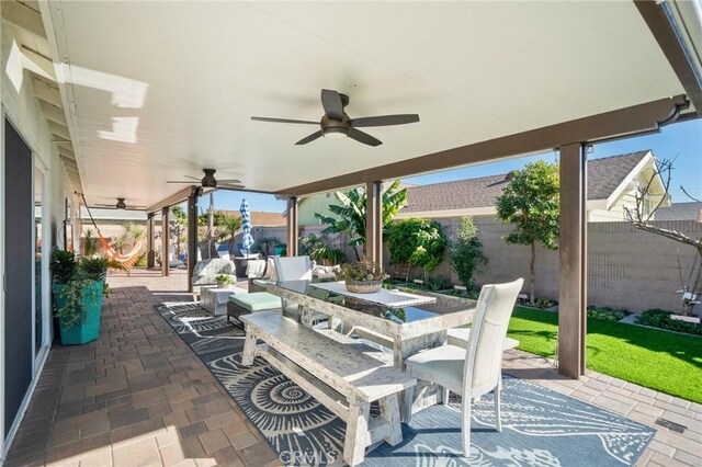 view of patio with ceiling fan and an outdoor living space