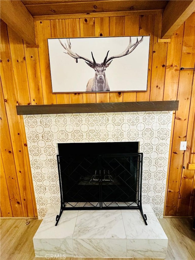 interior details with wood walls and a fireplace