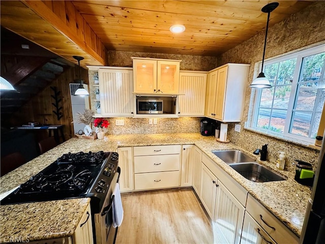 kitchen with appliances with stainless steel finishes, wooden ceiling, a sink, and pendant lighting