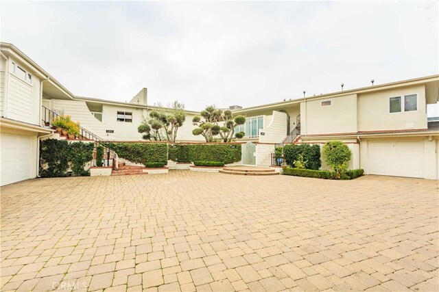 1203 Bayside Dr, Corona Del Mar, CA 92625 - view of front of property featuring decorative driveway, a garage, and stucco siding