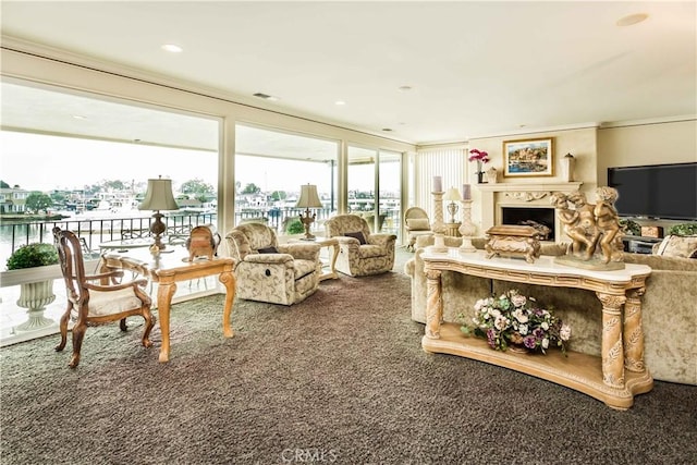 living room featuring a water view, carpet, and ornamental molding