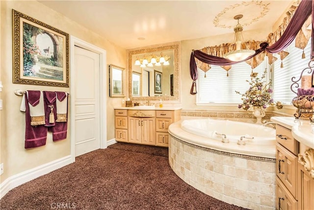 bathroom with tiled tub and vanity