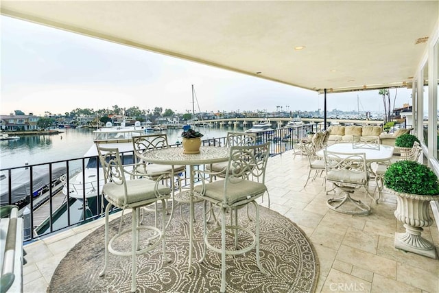 view of patio / terrace with an outdoor living space and a water view