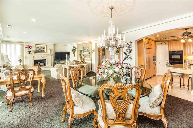 1203 Bayside Dr, Corona Del Mar, CA 92625 - dining area featuring ornamental molding, arched walkways, a chandelier, light tile patterned floors, and a fireplace with raised hearth