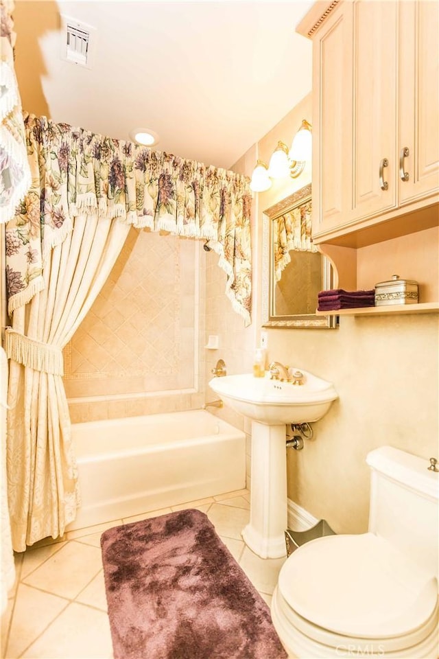 bathroom featuring tile patterned flooring and toilet