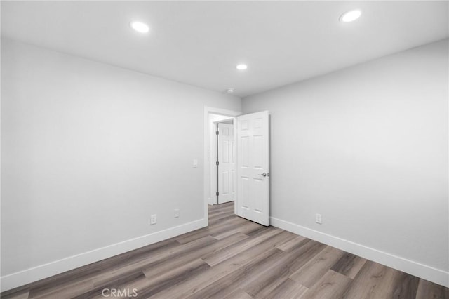 unfurnished room featuring hardwood / wood-style flooring