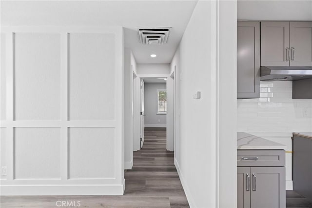 hallway with hardwood / wood-style floors