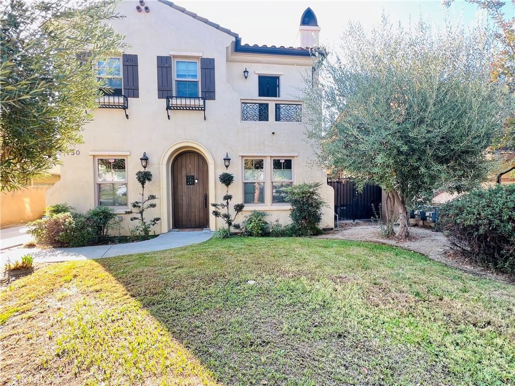 mediterranean / spanish-style home with a front yard