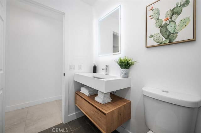 bathroom featuring toilet and tile patterned flooring