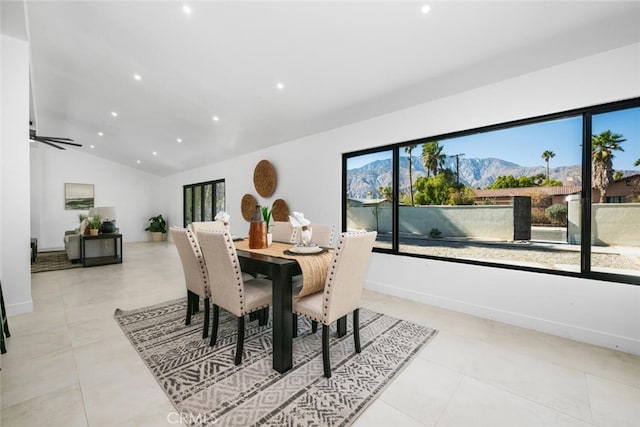 dining space with vaulted ceiling, ceiling fan, and a mountain view