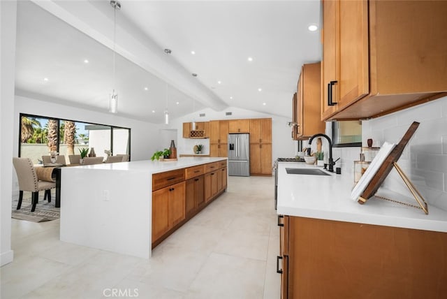 kitchen with decorative light fixtures, tasteful backsplash, vaulted ceiling with beams, sink, and stainless steel fridge with ice dispenser