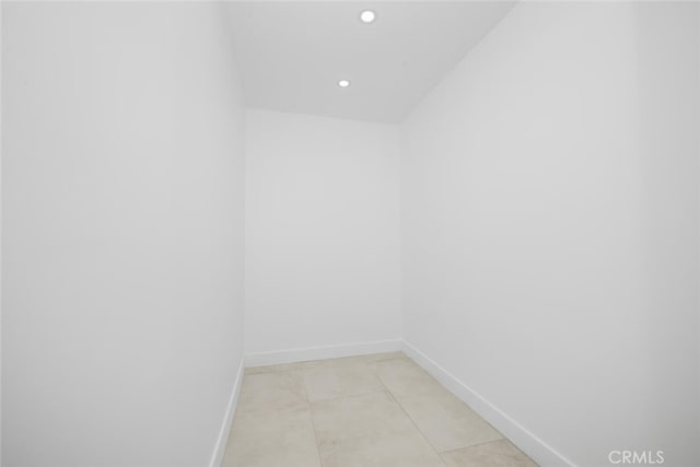empty room featuring baseboards and recessed lighting