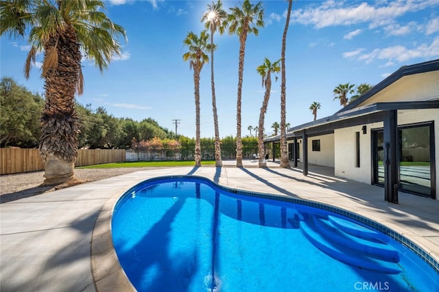 view of swimming pool featuring a patio area