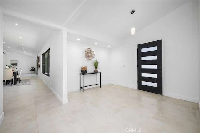 entrance foyer featuring vaulted ceiling with beams