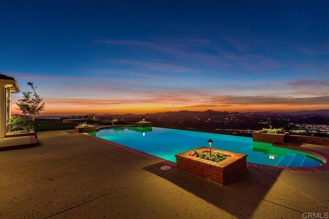 view of pool at dusk