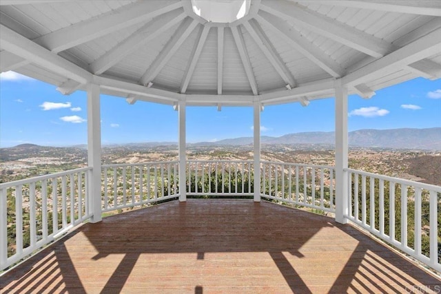 wooden deck with a gazebo and a mountain view