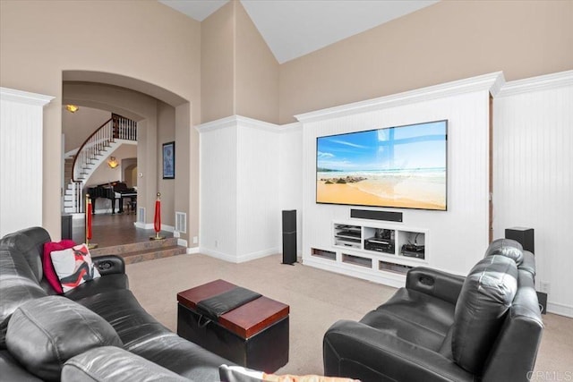 living room featuring built in features, carpet floors, and high vaulted ceiling