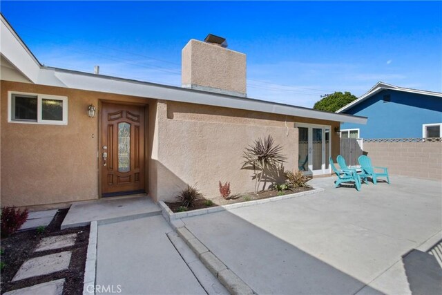 doorway to property featuring a patio