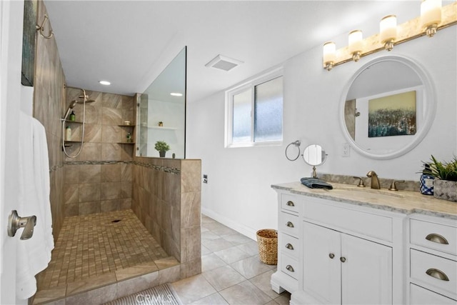 bathroom featuring visible vents, walk in shower, vanity, and tile patterned floors