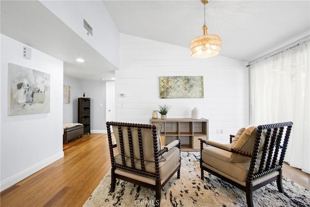 sitting room featuring visible vents, baseboards, lofted ceiling, wood finished floors, and recessed lighting