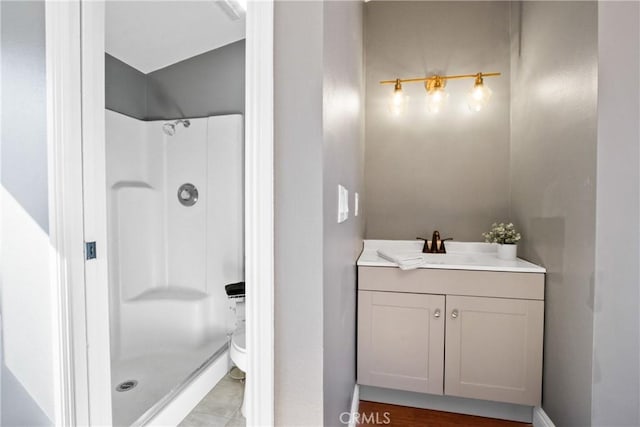 bathroom featuring a shower and vanity