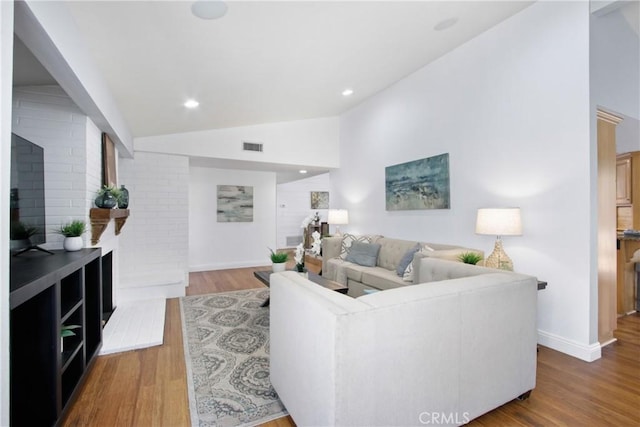 living room with high vaulted ceiling, baseboards, wood finished floors, and recessed lighting