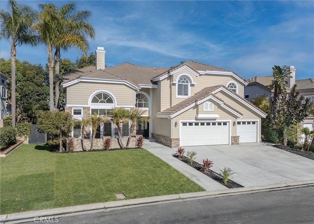 view of property with a garage and a front lawn