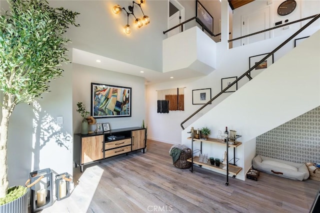 entryway with a high ceiling and light wood-type flooring