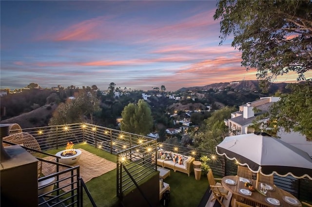 exterior space with an outdoor living space with a fire pit